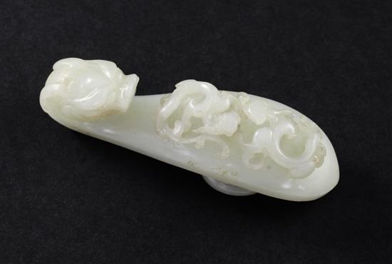 A Chinese white jade dragon belt hook, 18th century, 10cm, slight losses to chi-dragons, later piercings